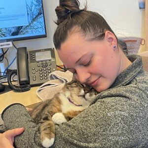 Vet staff cuddling a cat