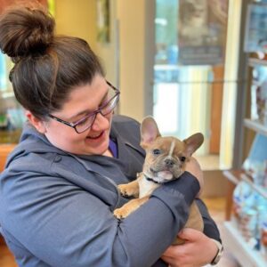 woman holding a puppy